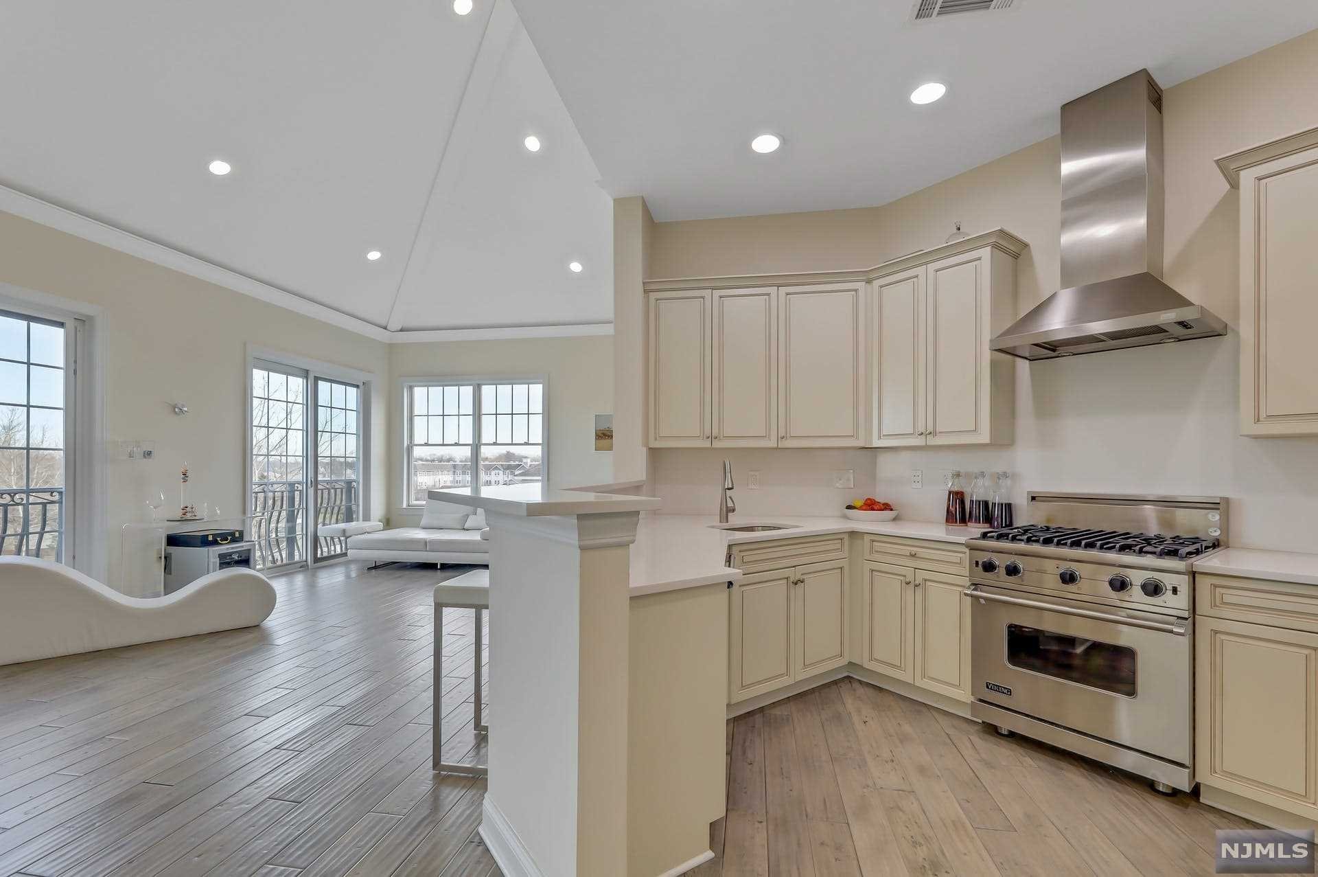 The most Luxurious Unit in Tenafly's prime gated community The Plaza at Tenafly. Impeccably kept this fully customized unit boasts close to 2000 sf of livable space. The captivating floor to ceiling windows, hardwood floors, and the soaring ceilings creates a rich and airy open feel. The main level features an upscaled white kitchen with Quartz counters, Viking and Subzero stainless-steel appliances, a large living room, a den (can easily be converted to a third bedroom), a large bedroom suite, another full bathroom, and a laundry room. The captivating upper level is a unit on its own with a large bedroom, a huge master bath with a jacuzzi and a large WIC. This unit come with two parking spaces (one indoor and one outdoor), 24hr Sec, Common Area, Doorman, Elevator, Exercise Rm, Play Area, Outdoor pool. Nearby, shopping, schools, restaurants, and parks. Call to make an appointment Today!!