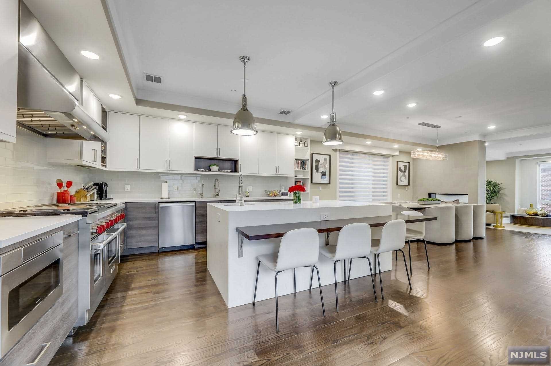 What a lifestyle in this, contemporary 3 years young townhouse that feels like a single-family home. Featuring modern open space plan that allows the eye to move throughout without interruption. A 'to-die for' sleek, eat-in gourmet kitchen with stainless steel top appliances, a large dining area separated from the living room by a two-sided gas fireplace. Steel and glass railings lead to the second floor where the large modern master suite is with views of the Hudson River. Two additional bedrooms, a full bath and the laundry room are on the same floor. The straight clean lines continue to the third and top floor connecting the outdoor terrace to an office space with phenomenal vistas of the GWB, Hudson River and Manhattan Skyline. On this floor is also another bedroom and bathroom. Totaling over 4000 sf of livable space this house is close to the ferry, shopping, local schools, and NYC