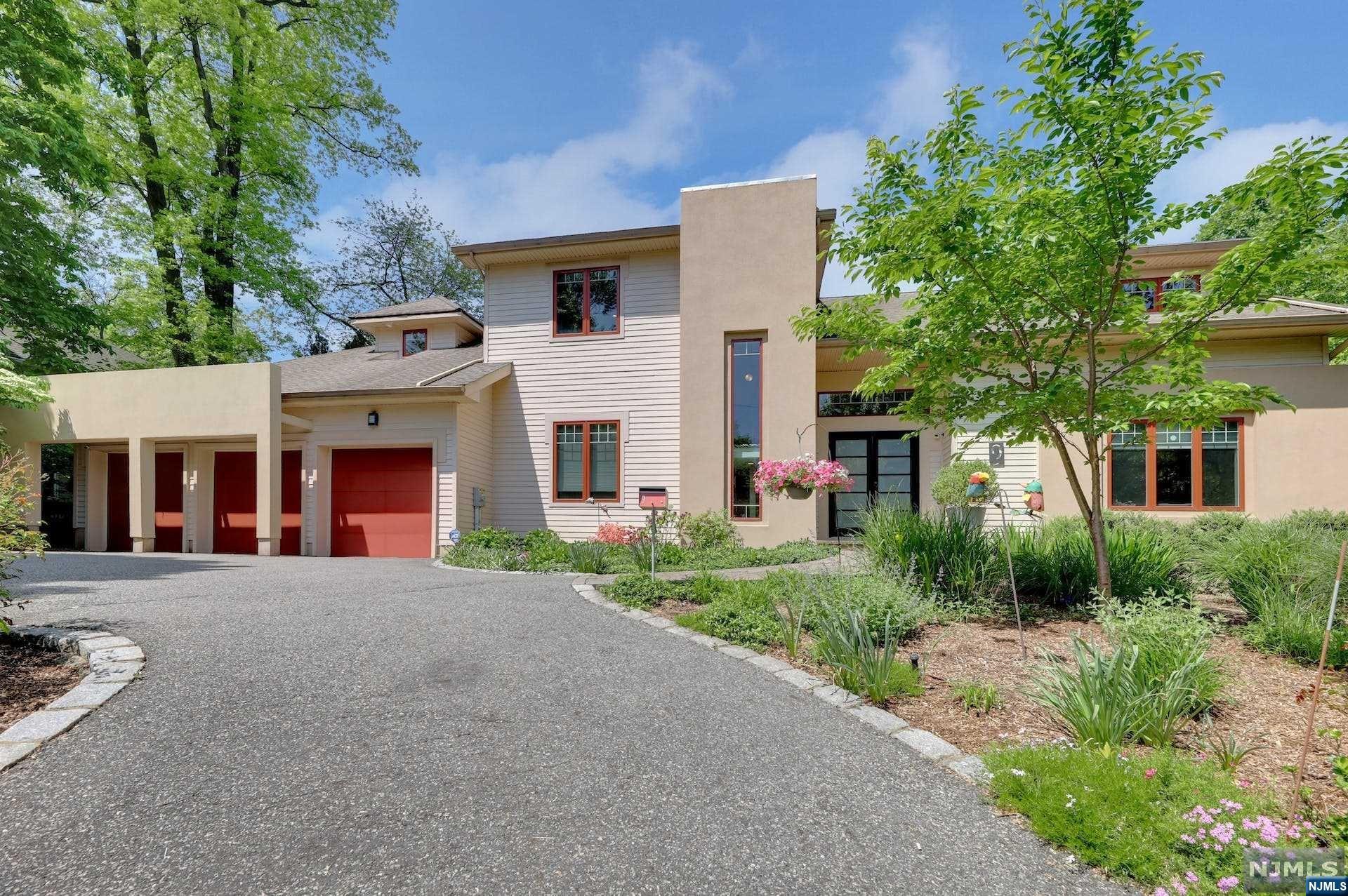 >>>CALL LISTING AGENT ANAT EISENBERG 201.341.4765
Tribeca-inspired loft-style design on the E Hill of Tenafly.  Situated on over 0.5 acres of private property featuring 5 bedrooms and 4.5 bathrooms (can fit in a pool.)
First floor boasts an open layout with 10' ceilings the living. room with a cozy fireplace, a dining room, a family room, a state-of-the-art gourmet kitchen, a center island, a library, a powder room, a mudroom, and a 3-car attached garage. 

Enjoy a breathtaking view of the stunning backyard, lush landscaping, and paver patio from these rooms. 
The 2nd floor features a luxurious master suite with a spa-like master bath, Jacuzzi, and a large walk-in closet. An en-suite bedroom, and two additional bedrooms with a J& J bathroom.
The walk-out lower level offers a recreation room, a bedroom, a full bath, a laundry room, and ample storage space. 
Hardwood floors throughout, radiant heat in all bath bathrooms, and the lower level.
Many recent updates.