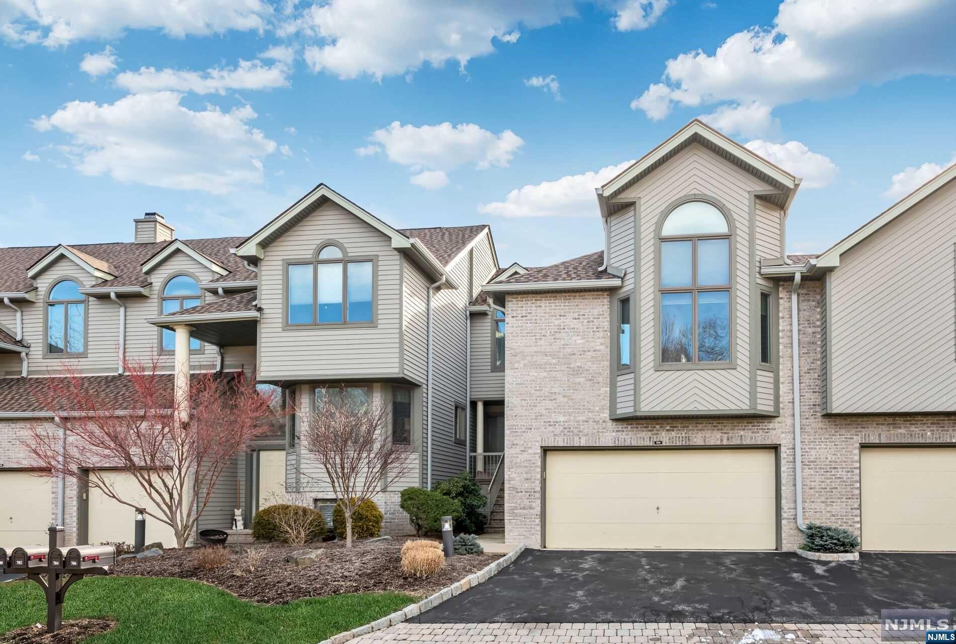 EXCEPTIONAL OPPORTUNITY! SELLER OFFERING A CREDIT OF $20,0000 TO BUYERS AT ClOSING. Don't miss out on this amazing chance to own this home with added financial flexibility. Coveted light filled Cascade Model nestled away in Northwoods. 704 Holly boasts great space for a variety of lifestyles w/approx 3,000 sf, 4 beds and 3.5 baths. Enjoy the eat-in kit which opens to the DR with SG doors that lead to the deck- perfect for al-fresco dining! The 2 story gr rm features skylights, wet bar and WB fpl. A PR and att 2 car gar complete this fl. The mezzanine features a spacious primary suite w/ vaulted ceiling, expansive windows and a generously sized WIC. The spacious bath includes a jetted tub and separate shower. The 2nd fl hosts 2 nicely sized bedrms, full bth and laundry. The LL provides addt'l finished and functional space w/rec room, bedroom, full bth and storage. Amenities include pool, clubhouse w/gym, common area, tennis, and playground. 3 yr paving assessment $125 per month.