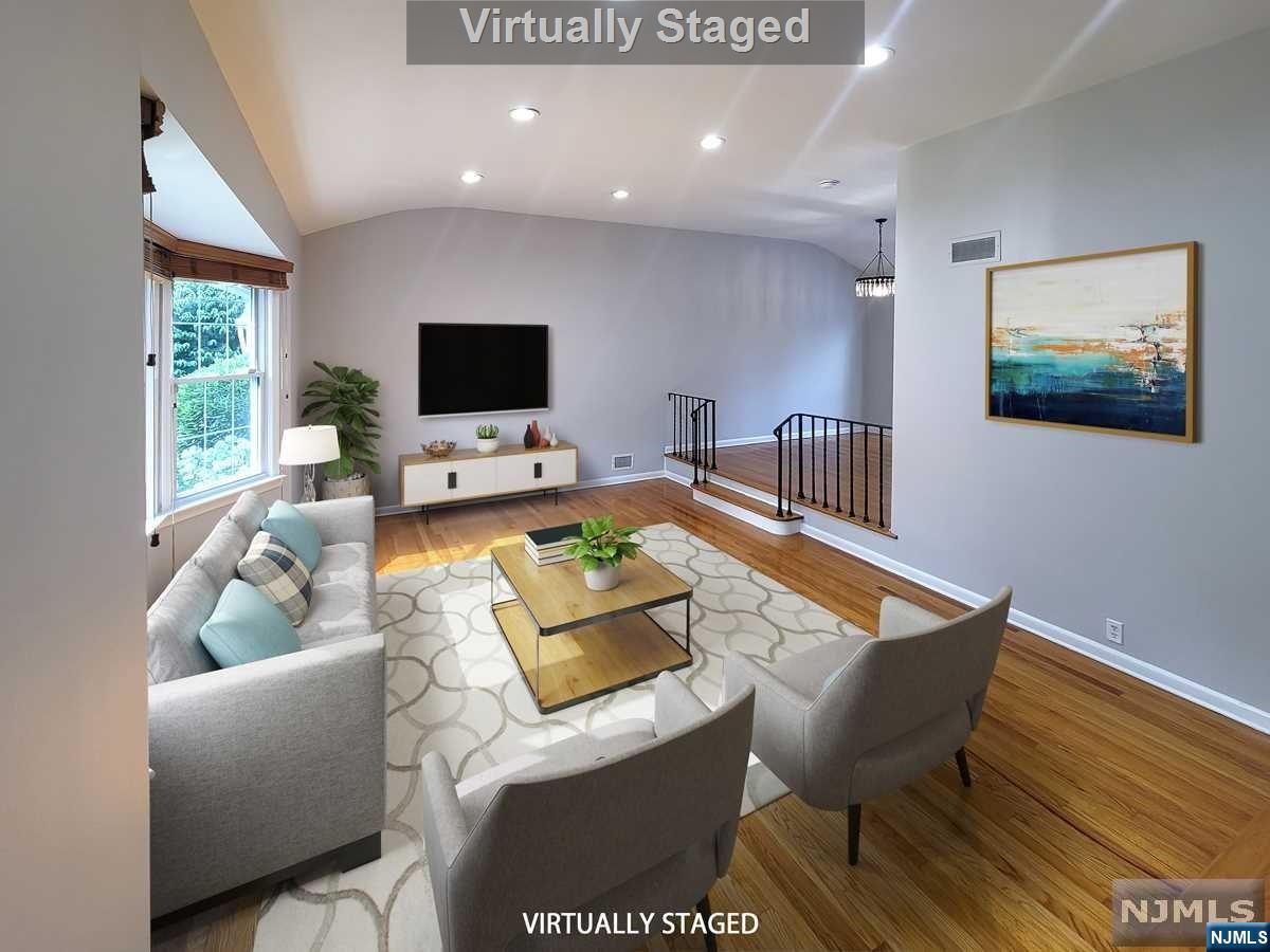 >>Contact Anat the listing agent at 201.341.4765<<This beautifully designed four-level split home features open space and abundant natural light on a tranquil street. The house was just painted, with an enhanced kitchen, rebuffed hardwood floors, and two-zone heating and central air systems. 
Recent renovations include the roof, a large open kitchen, and a spacious patio. The expansive master suite offers a whirlpool tub, separate shower, skylights, and a large walk-in closet. The great room opens with its sliding glass door to a generous covered patio and a fantastic backyard. It is conveniently located near NYC transportation and schools.