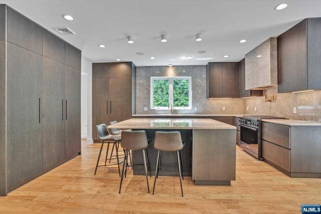 A magnificent 8-year young new construction! This extraordinary home boasts 5 bedrooms and 4.5 bathrooms and is located on a quiet street minutes to three schools.
 Featuring a fabulous LR, a formal DR, and a brilliantly lit FR with a gas-burning fireplace seamlessly connected to THE CHEF’S GRADE BRAND NEW KITCHEN. This Kuche & Cucina kitchen features Dacor appliances and stunning cabinetry.
The spacious master suite is a true retreat, with soaring high ceilings, walk-in closets, and a luxurious master bathroom featuring a six-foot free-standing tub, a grand shower, and a double-size vanity. On the 2nd floor are two other bedrooms sharing a J&J bath and an ensuite bedroom. Complementing the 2nd floor is an office and laundry room
The fully finished basement with a full bathroom, a large recreation area,  a bedroom large windows and storage complements this gorgeous retreat.
The backyard is private,  surrounded by fully grown trees and great outdoor living