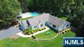 Spectacular location & setting! Renovated 4+ BR home with pool & poolhouse in sought-after San Jacinto Estates in Allendale. Completely redone top-to-bottom in 2014, this sprawling home boasts beautiful hardwood floors, high ceilings, oversized windows & luxurious finishes throughout. Built for entertaining yet practical for everyday living. The main level has a wonderful open floor plan, 4 bedrooms including the primary suite, 2.5 baths, custom office, laundry, mudroom & 2 car garage. The gourmet kitchen with island enjoys views over the amazing private acre grounds. Designed for indoor/outdoor living with a heated pool and incredible pool-house (redone in 2019) with full kitchen, full bath, laundry, huge covered porch, change rooms & bluestone patio. Finished lower level with potential 5th BR, full bath, wet bar, playroom & storage. Nothing to do but unpack. Top-rated school district; Truly the best of one level living! Owner has NJ real estate license.