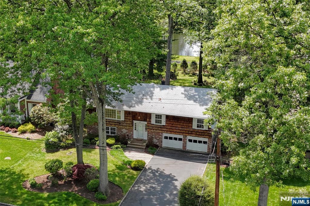 Fantastic opportunity with lake and golf course views- one of the few in the desirable Ramsey Golf and Country Club! Proudly built and owned by just one family for over 50 years, this home sits on a beautifully positioned, deep oversized lot, with serene water views, and mature landscaping. Newer kitchen and baths with quality cabinetry, high end SS appliances and full house generator. Additionally, you'll find 4 generously sized bedrooms, 3 full baths (one with jacuzzi tub) and outdoor living space with deck and patio. Whether you are drawn to its solid bones or inspired to renovate, the potential is limitless. Homes in this location are few and far between. See for yourself what the RGCC lifestyle offers: 18 hole golf, pool, platform/pickleball plus a brand new clubhouse (July '25). Located next to Ramsey's vibrant downtown with its fine dining and award-winning farmer's market, top rated schools and NYC transportation, this checks off all the boxes! Membership required.