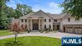 Timeless elegance greets you the moment you step into this stunning young Center Hall Colonial. Offering an impressive 8,744 square feet across the first and second floors, this home features soaring ceilings, generously sized rooms, and radiant heat throughout. The custom-designed chefâ€™s eat-in kitchen is a true showstopper, complete with a full barâ€”perfect for entertaining. Additional highlights include a private home theater, a massive unfinished basement with rough plumbing for an eighth bath, and a spacious bonus suite with it's own en-suite bath and built-in closet. The luxurious primary suite feels like a retreat, featuring a cozy sitting area, double-sided fireplace, spa-like bath, and two expansive built-in closets. Each of the five additional bedrooms includes it's own en-suite, for a total of seven beautifully appointed bathrooms. Set on 1.63 acres, this home also includes a three-car garage, three fireplaces, exquisite millwork, and elegant cove lighting throughout. Outside, enjoy a circular driveway, large patio ideal for entertaining, and a serene, park-like yard bathed in natural sunlight.
