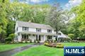 Discover tranquility, timeless charm, and exceptional privacy in this beautifully expanded colonial, nestled on a rare triple cul-de-sac in the sought-after North Gate section. Before stepping inside, enjoy the covered front porch, ideally situated to overlook the lush, mature landscaping that frames the circular driveway. Inside, the welcoming foyer is flanked by an office and a formal DR w/Fpl. Delight in the chefâ€™s kitchen, boasting custom rock maple Salerno cabinetry, high-end appliances, center island, wet bar, peninsula, and soaring vaulted ceiling, perfect for culinary creativity and casual gatherings. Or, unwind by the gas fpl in the inviting den or transition effortlessly into the sun-drenched 3-season sunroom, accessible from both the DR and den-ideal for seamless indoor-outdoor living and entertaining. There's more! A spacious Gr Rm off the kitchen + a full bth, PR/Lndry, and access to the grade level 3-car att garage. Upstairs, the primary suite offers a WIC and renovated bath. Three additional bedrooms share a thoughtfully designed Jack-and-Jill bathroom. A 2nd staircase off the Gr Rm leads to a flexible fifth br/bonus space- perfect for guests, a studio, or your next big idea! The partially finished LL offers even more living space. Upgrades include security system, generator, irrigation, siding, newer A/C system and more! Impeccably maintained and move-in ready. Close to ITC, Market Basket, and everything Franklin Lakes has to offerâ€”this home truly has it a