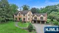 Welcome to this Colonial Style single family home with Scenic Views & Expansive Living Space. Experience timeless elegance and modern comfort in this impressive Colonial-style estate, offering over 6,600 sq ft of finished living space on a 1.848-acre lot in a serene, scenic setting overlooking the Haledon Reservoir and Franklin Lakes Nature Preserve. Features 4,614 sq ft main home + 2,010 sq ft finished walk-out basement, 13 rooms total, including 6 spacious bedrooms and 4 full bathrooms, Hardwood and tile floors throughout, Summer kitchen, Accessory Unit, 1,251 sq ft separate structure â€” perfect for a guest suite, home office, studio or garage. Expansive 2,258 sq ft deck, Two driveways for added privacy and access, 3-car attached garage Enjoy tranquil surroundings with unmatched access to outdoor recreation, all while being just minutes from major highways, top-rated schools, dining and shopping.This one-of-a-kind property blends luxury, flexibility, and privacy â€” a true gem in an exceptional location.