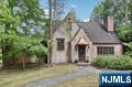 Rare opportunity for an amazing property and Tudor home located in desirable Ho-Ho-Kus, with charming details and loads of character. Set on a gorgeous private lot of an acre, with a private pond for ice skating in the winter and located at the rear of the property on Saddle River for fishing trout in the spring, the possibilities are endless! The backyard extends to the Saddle River and is opposite Ho-Ho-Kus East Park with its picturesque walking trails. This special home, loved by only two families since it was built, has hardwood floors, leaded windows, curved archways, cathedral ceilings, and so many other beautiful details to love and appreciate. Spacious bedrooms all have hardwood floors, and the home has three full and one half baths. The first floor includes a Living Room with Fireplace and beautiful built-ins, a Dining Room with Ceiling details, and an adjacent den/office with access out to a rear terrace. Continuing through to the kitchen, there is a breakfast area (with outside access) and Family Room addition with cathedral ceilings and a wood-burning fireplace. Enjoy an impressive wall of windows overlooking your lush and expansive private rear yard. Enjoy the wood paneled lower level bar room or the adjacent screened in porch. With a 500' deep property, it's an opportunity to bring your ideas to this idyllic setting and to enjoy decades of memories, both inside and outside, in the highly sought after Ho-Ho-Kus community.