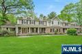 Located on a quiet cul-de-sac, this stately 5-bedroom Colonial with blue stone porch offers timeless elegance with today's modern conveniences. The gourmet kitchen, equipped with top-tier appliances, includes ample workspace, a fireplace and a butler's pantry with wine cooler. Seamless access into the formal dining room or to the backyard patio is perfect for entertaining. The inviting family room boasts a fireplace, custom built-ins, and volume ceiling with skylights, creating a cozy vibe. The expansive primary suite is a retreat of its own, featuring a bonus room, beautiful bathroom and a huge walk-in closet. Three additional bedrooms, two full baths and the laundry room are located on this second floor level. A separate grade-level entrance leads to a private home office or guest bedroom suite, ensuring versatility for work or visitors. Step outside to a resort-like backyard, complete with an inground pool, paver patio, and lush landscaping, a perfect spot for relaxation or hosting gatherings. Other exceptional features include a home gym room, a 3 car heated garage, generator, security system and more! This exceptional home blends refined style with practical livingâ€”an opportunity not to be missed!
