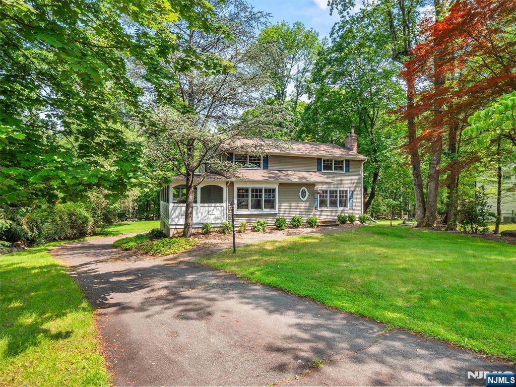 Set in an ideal location backing to a beautiful green area, this will not last long! Step inside to find gleaming hardwood floors throughout. Off the entry is a warm and inviting living room with a fireplace. The newly updated kitchen opens to a high-ceiling family room, perfect for entertaining. A dining room leads to a jaw-dropping three-season room, the perfect destination for gatherings. An updated full bath and laundry complete the main floor. Upstairs features a spacious primary bedroom, three generous bedrooms, and a full bath. The partially finished basement with access to a two-car garage offers even more space. Outside, enjoy a beautiful deck and a stunning private backyard. Enjoy Ramseyâ€™s quaint downtown, blue ribbon schools, and great commuting optionsâ€”this home truly has it all! WANT MORE INFO? CONTACT LISTING AGENT NICOLE MINETTI @ 201-388-0077/nicole@minettidennisgroup.com
