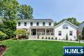This beautifully renovated home offers light-filled interiors, neutral finishes & exceptional curb appeal with new Hardiplank siding & a welcoming covered front porch. Located in a picturesque neighborhood with private wooded views, the backyard is a true retreat complete with a large deck, patio & sparkling pool. The spacious 1st floor boasts a formal living room with French doors, large dining room & a stunning new kitchen with a large center island, high end appliances, beverage station and sliders to the deck. Open floor plan to the bright family room with gas fireplace & wall of windows overlooking the backyard. A mudroom, powder room, laundry room & access to the 5th bedroom or bonus room adds convenience & flexibility. Upstairs, the primary suite includes a luxurious bathroom with vaulted ceiling, skylights & soaking tub with serene yard views. An additional ensuite, 2 more spacious bedrooms & a hall bath complete the level. The fully finished basement includes a large rec room, office/gym, full bath & potential 6th bedroom with its own garage access- ideal for guests, multigenerational living or a nanny suite. This home is one you wonâ€™t want to miss.