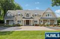 Bespoke Custom-built Colonial (2010) on 2.9 park-like acres with a breathtaking backyard oasis. This thoughtfully designed 7,500 SF residence on existing foundation is grand inside and out, featuring an infinity pool, bluestone and paver patios, built-in BBQ, and sweeping views of the Saddle River. A grand 2-story foyer greets you to an eat-in kitchen with radiant heated floors, Subzero/Wolf appliances and flow to a living space with fireplace. Family room addition with coffered ceiling, billiard room with a sophisticated wet bar, and formal dining room add to the entertainment appeal. Four total bedrooms upstairs, including the primary bedroom suite with a balcony, spa-bath, and oversized walk-in closet, plus a rec room/bonus 5th bedroom. Extra highlights: indoor/outdoor sound system, 3 attached garage spaces, whole house generator, high ceilings, quality craftsmanship, partially-finished basement with gym, and new roof (2023). A luxurious retreat in a truly spectacular setting.