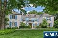 Exquisite 6-Bedroom French Manor-A Masterpiece of Design, Detail and Decor with Outdoor Oasis! Picture perfect with unparalleled warmth and beauty in an unbeatable location! Impeccable curb appeal and grand architecture set the stage! The majestic 2-story foyer with a sweeping bridal staircase opens into the formal Living Room and the formal Dining Room with 2 sets of elegant French doors. The sun-drenched chefâ€™s kitchen features a large center island, premium appliances and an expansive dining area with wall of glass that frames views of the outdoor space. The adjacent great room is beautifully appointed with coffered ceilings, intricate millwork, fireplace, rear staircase, and glass doors opening to the rear patio. Work in peace in the cherry library complete with rich craftsmanship, built-ins and trim detail. Upstairs 6 spacious bedrooms and 5 luxurious full baths offer private comfort plus enjoy the bonus built-in work/study space-perfect for young learners or remote working. The primary suite is your personal sanctuary with a resplendent walk-in closet and spa-like bath-an indulgent retreat! The fully finished lower level expands your living space with media room, play area, exercise studio & more! Step outside to a professionally designed private paradise featuring breathtaking pool with hot tub and cascading waterfall, an outdoor fireplace, and a large dining and lounge area! Too many incredible features to listâ€”this is a home that must be seen to be fully apprecia
