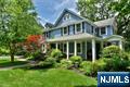 This one has it all! Quintessential charm & quality craftsmanship meets modern day conveniences. Beautiful 4BR 3FB farmhouse colonial perfectly located in close proximity to town, train and schools. Enjoy the wrap around lemonade porch with views of Memorial Park. First floor boasts charming EF/sitting area, LR (previously DR), lrg Fam Rm w/wood burning FPL, open to sunroom/office/den, large chef's kitchen w/center island, coffee/wet bar & SGD to deck, FB and large mudroom/laundry rm. Second floor has a lovely primary suite w/ high ceilings, walk-in closet, and spa-like private bath. 3 add bedrooms & FB complete this floor. Gorgeous HW floors, detail windows, loaded with charm. Bonus of newer 2 car detached garage w/workshop & addl finished bonus room above. Lovingly maintained, pride in ownership. Just some of the updates & enhancements over past 6 yrs incl: HVAC, HWH, R/O water system/softener, dehumidification sys, 2 roof sections, replaced multiple exterior doors, shower door, updated laundry rm, pantry shelving, backsplash, plantation shutters, staircase runner, re-stained front porch & replaced columns, updates to deck/railings/patio, planting of many trees, sod & added F&B sprinklers. So much to enjoy. Just move right in!