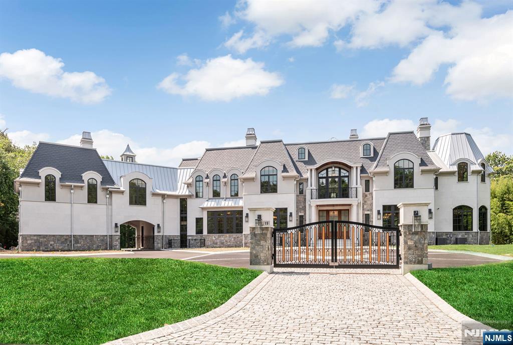 A masterfully crafted French Provincial Estate in Alpineâ€™s prestigious Rio Vista. Situated on a prime south-facing lot with views of Montammy Country Club, this 8BR, 9FB, 2HB residence spans four levels with elevator access and offers timeless design and livability. Exterior features include Synthetic Slate Roof, Connecticut-cut granite, Turkish Limestone, and Italian Porcelain Terraces. The backyard oasis boasts a 20' wide infinity-edge pool with ongrade wading pool and a heated Loggia with Phantom Screens for year-round use. The lower level is a wellness retreat with a sport court, gaming lounge, spa suite with infrared sauna, steam & massage rooms, and full gym. Additional highlights: 6 fireplaces, ensuite bedrooms, finished attic, home office, surround sound, security system, and partial walk-out lower level. Designed to be lived in and built to the highest standardsâ€”this is luxury redefined.