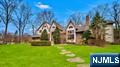 This stunning 4 bedroom, 5 & 1 half bath center hall colonial blends timeless elegance with modern luxury. A grand entry foyer welcomes you into a warm, inviting space where natural light highlights rich textures and fine craftsmanship. The great room, anchored by a cozy fireplace, flows effortlessly into the family room. The sunken dining room, with fireplace, opens to a custom Watts & Wright kitchen with imported English white oak cabinetry, adding warmth and sophistication. A spacious 1st fl office complete with custom cabinetry, fireplace, and full bath, offers its own private entrance. The second floor features 4 bedrooms, 3 ensuite bedrooms and a luxurious principal ensuite with dual closets, fireplace, and spa like bath. The full finished walkout basement boasts open space, storage, a bonus room with full bathroom. Outdoors, enjoy the tranquility of mature landscaping, relax by the pool, unwind beneath the pergola, or dine alfresco under the covered patio. A perfect blend of comfort, luxury, & privacy. A new septic system is in the process of being installed prior to closing, with estimated completion mid to late Julyâ€”just in time to move in and enjoy summer.