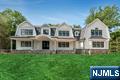 Stunning NEW construction Hampton style home located on the East Hill of Upper Saddle River is the epitome of luxury. This custom-built masterpiece by high end builder showcases 7,961 sq ft on 3 levels. Gorgeous exterior w/ covered front porch, sweeping roof lines & large level property. Enter to a 2 story EF w/ wide plank white oak floors, banquet size DR w/cstm clg, large LR w/panel walls. Dream designer kitchen w/ breakfast rm with all the amenities, custom island, high end appliances, built-in coffee bar, opens to outdoor living space w/raised 36' x18' bluestone patio w/outdoor kitch & FP. 2-story great rm w/ vaulted ceiling, custom beams & FP opens to patio. First fl BR, full bath, pantry, butler pantry, powder rm, & built-in mudroom area w/ access to 3-car garage w/ EV charger complete the 1st level. The second level offers 5 large BRs, 3 en-suite, 2 Jack & Jill, office, & laundry rm. The primary suite is a masterpiece w/ vaulted ceiling showcasing custom beams, FP, 2 WICs, & luxurious bath w/ oversized marble shower, dual vanity & soaking tub. The finished lower lvl offers a 7th BR, full bath, gym, theater, rec area, kitchen, & 2nd laundry rm. CAT5 cables all BRs, gym, theater, office, & great rm. Movie rm w/ 120 in. retractable acoustic weave screen, projector w/ wall speaker subwoofers & data tower. Security w/ 16 port w/ 9 cameras. Prewired for 6 Wifi hotspots. Wired speakers and dedicated amps to kitch, back patio & gym. 26 KW generator. Truly exceptional!