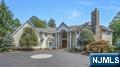 Set in one of Franklin Lakesâ€™ most prestigious neighborhoods, this extraordinary residence blends timeless elegance with modern comfort across three expansive levels. Designed for luxury living and effortless entertaining, it features 5 ensuite bedrooms, 6 full and 2 half baths and a 3car garage. A dramatic two story foyer opens to a formal dining room with butlerâ€™s pantry, a refined receiving room with fireplace, kitchen with high-end appliances, custom cabinetry, informal dining, and a generous walk-in pantry. The kitchen flows into the great room, where a soaring ceiling and stone fireplace create an impressive centerpiece. The first floor also includes a sun room, handsome office with coffered ceiling, a bedroom suite, and two powder rooms, with doors to terraced patios designed for entertaining by the outdoor fireplace, built-in grill, pool, spa, and sprawling lawn. Upstairs, reached by front or rear staircases, are four ensuite bedrooms, a spacious family lounge, full laundry, and a walk-up attic. The private primary suite offers a sitting lounge with fireplace, spa-like bath, and oversized closets. The walkout lower level is equally compelling with a full gym, media room, billiards area, wine cellar, summer kitchen, and bath with steam shower. Outside, resort style grounds showcase manicured lawns, expansive patios, and a heated gunite pool with spa, an ideal backdrop for relaxation and entertaining in one of Bergen Countyâ€™s most desirable communities.