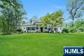 Welcome to this beautifully appointed Saddle River residence, set on a picturesque one acre, tree lined street. This 4 bedroom, 3 full and 2 half bath home blends elegance and comfort with generous living spaces. The first floor boasts 9â€™ ceilings and a formal foyer that opens to a grand dining room, a formal sitting room, and a spacious family room with fireplace, custom built ins, and large windows that flood the space with natural light. A full ensuite bedroom is perfect for guests or one floor living. The expansive eat in kitchen, complete with island and walk in pantry, seamlessly connects to the family and dining room. Two guest baths and direct access to the attached two car garage complete the first evel. Upstairs, youâ€™ll find an additional ensuite bedroom, two well sized bedrooms, and a main bath. The full walkout basement offers endless potential, ready to be finished into the ultimate recreation or entertainment space. Nestled in one of Bergen Countyâ€™s most desirable communities, this property offers the perfect combination of space, functionality, and opportunity to create your dream home.