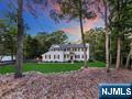 Offered up is an elegant and natural beauty nestled on 2 parklike acres in desirable Upper Saddle River. This meticulously renovated home awaits you. At the center of the house is the kitchen equipped with high-end finishes to experience the ultimate culinary lifestyle. Not to be missed is the family room off the kitchen and gorgeous sun room over looking the rear yard. The dining room, living room w/gas fpl and powder room complete the main floor. It has plenty of space to entertain, but also enough privacy for those working form home. Ascend upstairs to find a well designed layout featuring four generous bedrooms and two full bathrooms. Anchored with the primary suite which has many closets and a full ensuite. There is a large finished basement with a wood burning fpl and pool table. The basement is walk out. Adjacent is the laundry room with ample storage. Hardwood floors throughout with many finishing touches. Listen to the babbling brook in the gazebo or spend a cool night by the fire pit