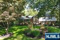 Located in the prestigious Hartung Section of Wyckoff, this exceptional home offers luxurious living both inside and out. The private backyard oasis features a 36,000-gallon heated gunite pool, complete with integrated lighting, speakers, and a cabana with a TV setupâ€”perfect for entertaining or relaxing in style. Inside, the home showcases custom woodwork, detailed trim, and elegant moldings throughout. The kitchen has been updated with high-end Bosch appliances and a Frigidaire refrigerator, catering to both everyday living and gourmet cooking. All bathrooms have been newly renovated, combining modern design with functionality. Enjoy built-in entertainment speakers on the second and third floors, creating a seamless audio experience throughout the home. The finished basement offers a spacious recreation room, a home office, and a possible fifth bedroom, providing flexible living options. Additional features include a whole-house generator capable of powering not only the home but also the pool, ensuring comfort and convenience year-round. Chimney and fireplace in as is condition no known issues.