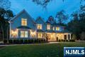 Welcome to this approx. 10,255 sq. ft. Center Hall Colonial offering 5 bedrooms, 5 full baths, and 2 half baths. A classic lemonade porch wraps from the front to the right side, welcoming you into an elegant interior with 10 ft ceilings on the first floor and 9 ft ceilings on the second. Each bedroom features tray ceilings, while detailed trimwork and wainscoting accent both staircases and extend into the fully finished lower level with 9.5 ft ceilings, a fireplace, and a full bath. The gourmet chefâ€™s kitchen is the heart of the home, showcasing an oversized marble island, Thermador appliances, a butlerâ€™s pantry, a large bar, and a dramatic two-story breakfast room with French doors opening to a blue stone patio and private backyard. The first floor also offers a family room with fireplace, formal living and dining rooms, an office, a mudroom, a powder room, and an additional full bath. The lower level is designed for entertainment with a private movie theater, while the resort-style backyard features a heated saltwater pool, creating the perfect space for relaxation and gatherings.