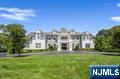 This Magnificent Colonial blends classic elegance with modern amenities, situated in sought-after South Gate. The residence features expansive living spaces, including a grand foyer, a formal dining room, and a cozy yet sophisticated living area with a fireplace. The chef's kitchen boasts high-end appliances, custom cabinetry, and a spacious island, perfect for entertaining. Each bedroom offers generous proportions, with the master suite showcasing a spa-like ensuite bathroom and a walk-in closet. Outside, the meticulously landscaped grounds include a patio, ideal for al fresco dining, and a swimming pool surrounded by lush greenery. Additional highlights include hardwood flooring, intricate moldings, and smart home technology throughout. This property is a true retreat, combining timeless charm with contemporary luxury.