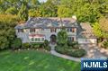 Welcome to the Heart of Heights! Prepare to be captivated by this approx. 6,000 SF Center Hall Colonial, set on one of the most beautiful streets in town on 0.57 acres of lush grounds. Sophistication and beautiful old-world Ridgewood character are evident upon entering the residence - much of which was part of a late 1980s addition/renovation - featuring 6 bedrooms, 5 full & 2 half bathrooms, 9-10â€™ ceilings, hardwood floors, and detailed moldings throughout. The entry foyer leads to a family room with oversized windows, built-ins, a fireplace, and a seamless flow into the kitchen, with a semi-vaulted ceiling, large eat-in area, skylights, and a butler pantry. A formal dining room, living room with a fireplace, sunroom/covered porch, and bedroom suite with its own entrance from the attached 2-car garage wrap up the 1st floor. On the 2nd level, the expansive primary bedroom offers 3 walk-in closets, fireplace, office, and spa-bath with a steam shower & jetted tub. Three more sizable bedrooms, and a 3rd floor with a full bath and flexible bedroom/office complete the upstairs. A partially finished basement offers 9â€™ ceilings and opportunity for extra finished space. The private, level, and fenced backyard w/ manicured landscaping, has a patio for entertaining and a 2nd garage that is multifunctional. Slate roof new in the early 2000s, new HVAC 15 years ago, whole house incredibly maintained. An exceptional home ideally located blocks from downtown, the train, Ridge ES, and GW