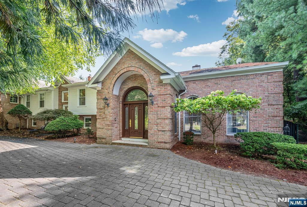 Welcome to this elegant 5-bedroom, 4-full & 3-half bathroom home, perfectly situated on a private 1.04-acre lot on a cul-de-sac.. With 5,347 square feet of living space, this residence seamlessly combines luxury with comfort. The heart of the home is a beautifully renovated kitchen, with incredible views of the pool and tennis court. The formal dining room offers a sophisticated setting for entertaining. Relax in the media/den area, which features a stylish bar perfect for hosting guests. The primary suite offers a luxurious retreat, complete with two spacious walk-in closets and an updated shower. Three of the additional bedrooms are en-suites, providing convenience and privacy, while another room can be used as a bedroom or a home office. Outside, enjoy a private pool and tennis court, offering a private oasis with ample opportunities for leisure and recreation. The serene setting is enhanced by the amenities and the attached four-car heated garage. Experience comfortable and elegant living in this distinguished Mahwah home, right on the boarder of Allendale.